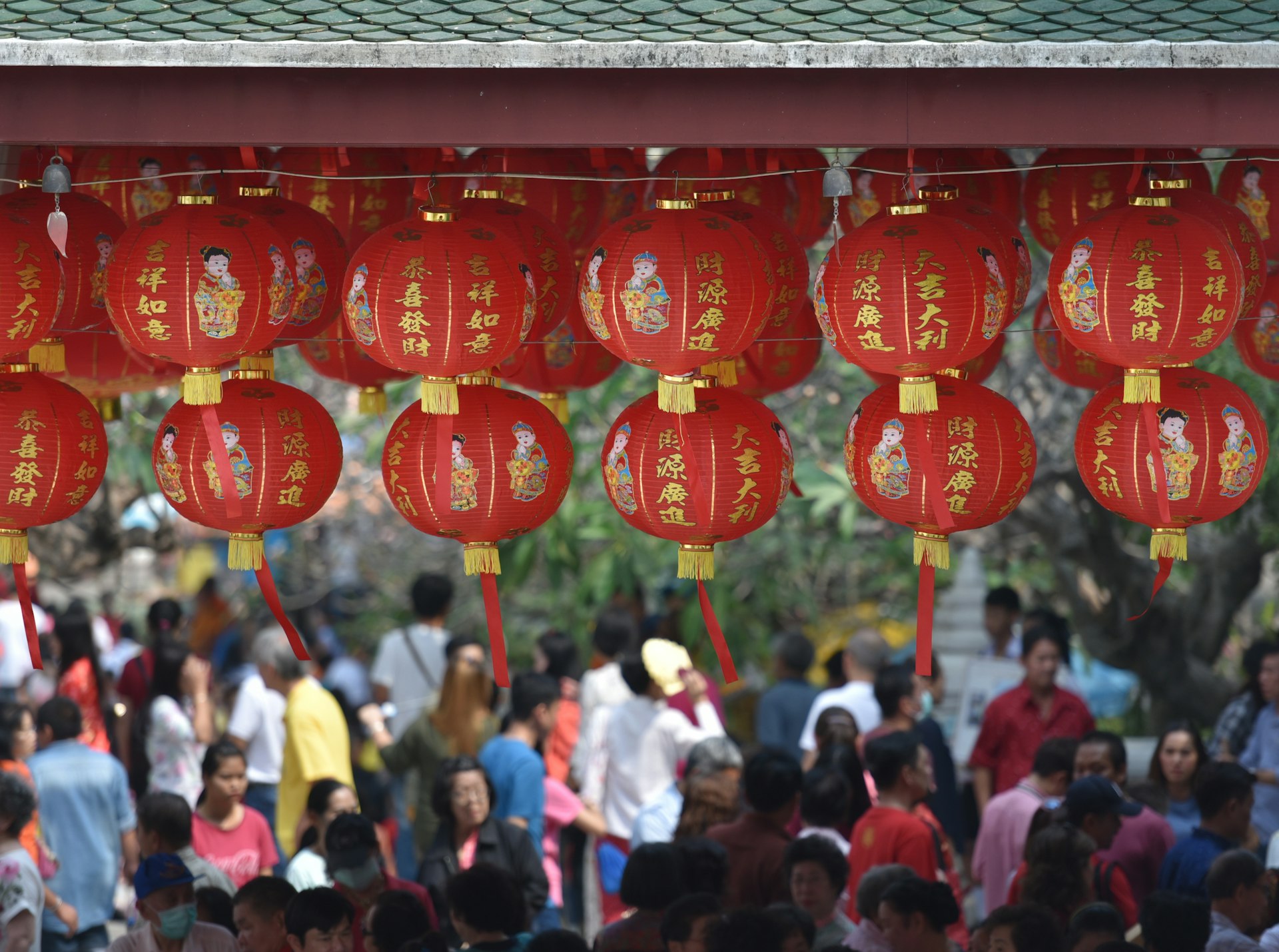 hanging round red lanterns near crowd at daytime